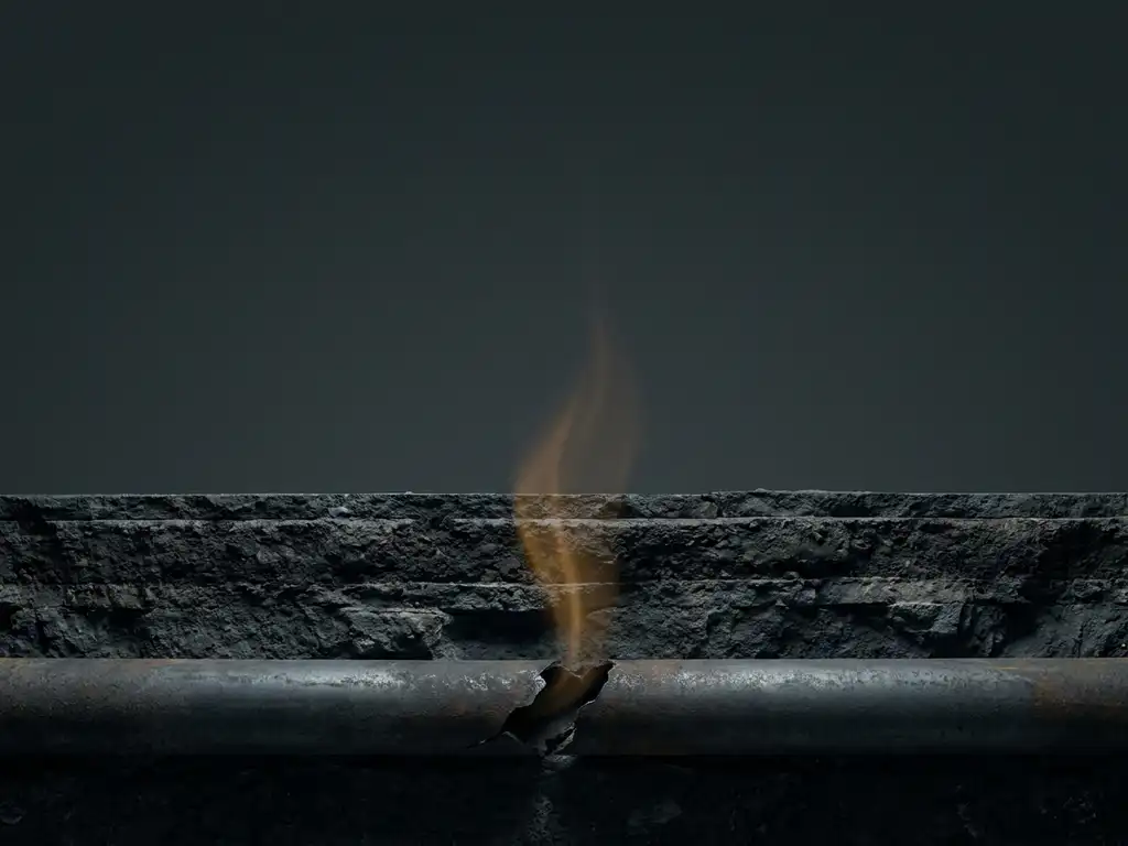 Cracked underground steel pipe leaking gas upward through dark soil layers in a cutaway cross-section view.